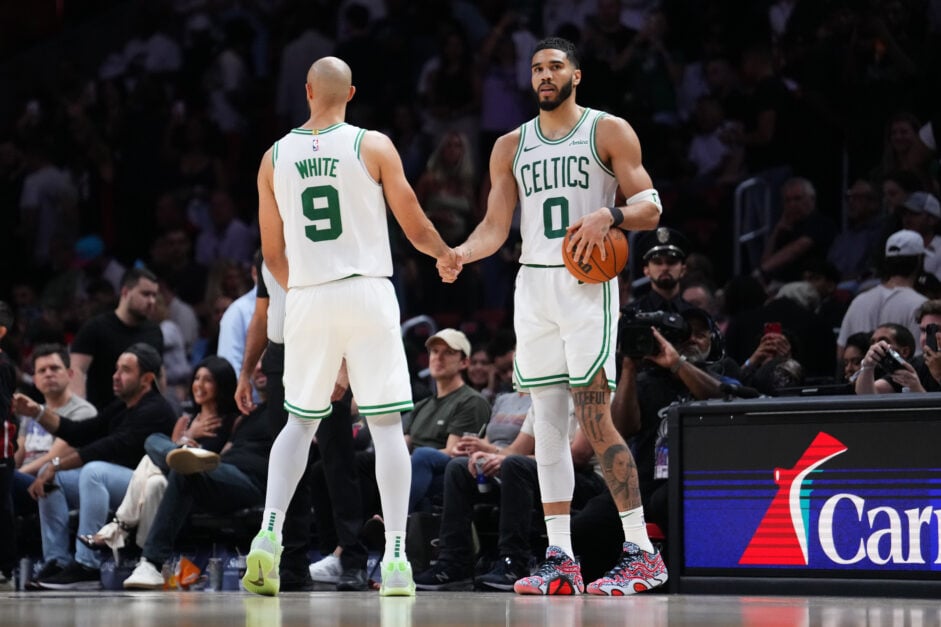 Boston Celtics guard Derrick White shakes hands with Jayson Tatum
