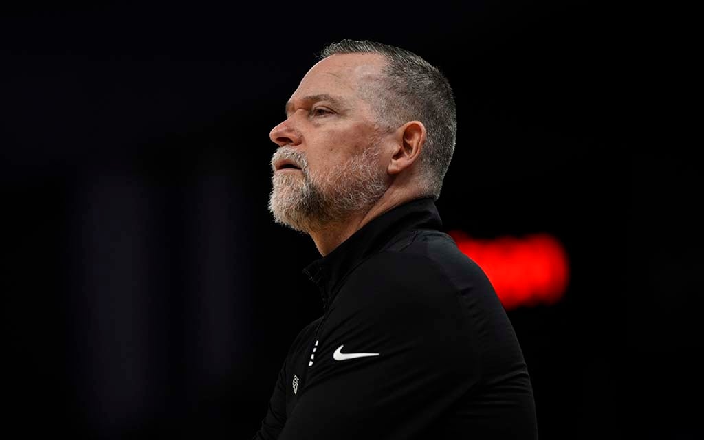 Mike Malone in front of a dark background.