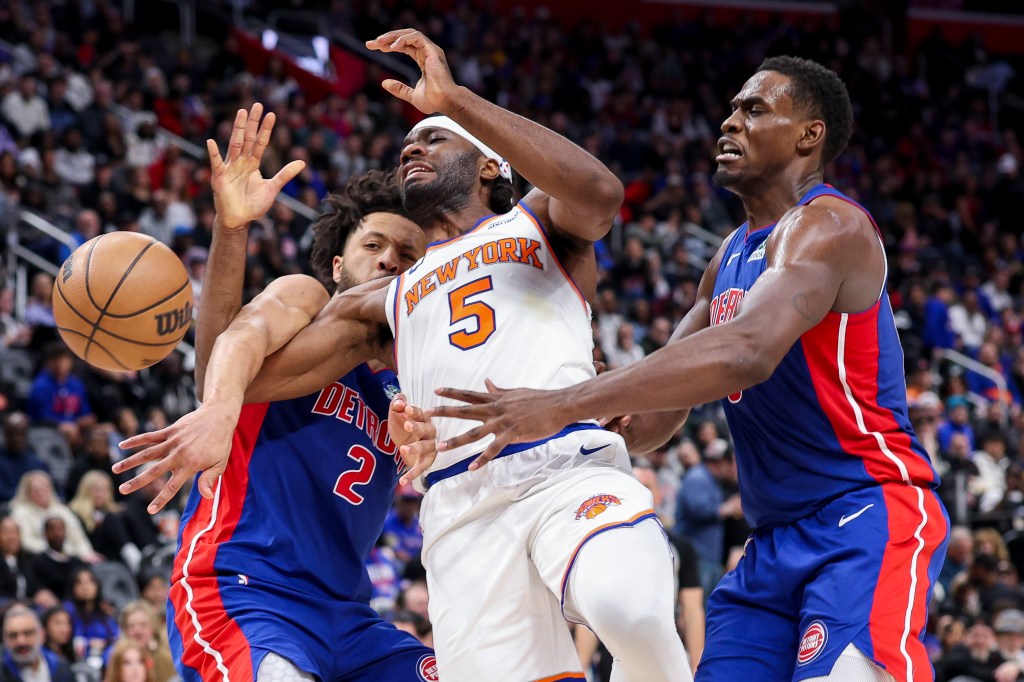 Precious Achiuwa (5) is hit by Cade Cunningham (2) and Jalen Duren (0) of the Detroit Pistons during the second quarter of a game at Little Caesars Arena on April 10, 2025. 