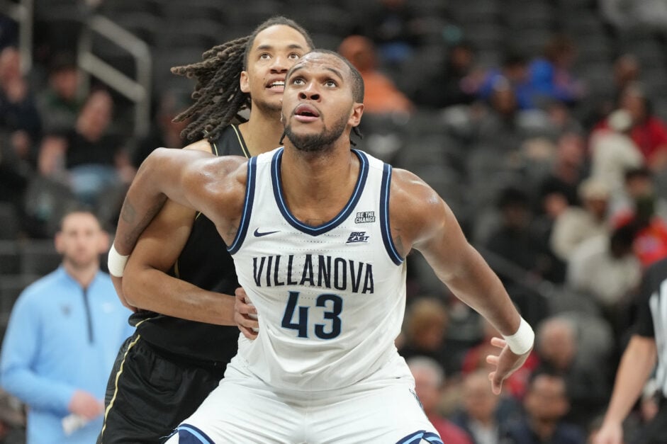 Eric Dixon holds off a defender for Villanova