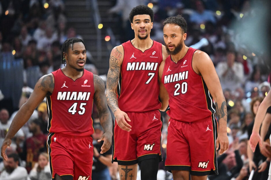 Davion Mitchell #45 Kel'el Ware #7 and Kyle Anderson #20 of the Miami Heat talk during the first half of game one of the first round of the Eastern Conference Playoffs against the Cleveland Cavaliers