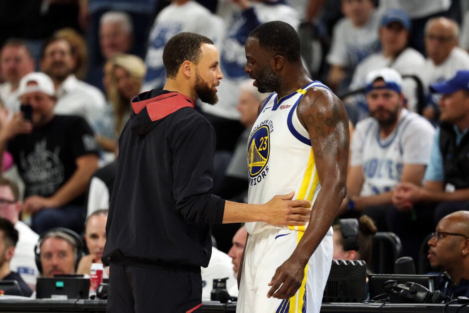 Golden State Warriors guard Stephen Curry talks to forward Draymond Green