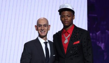 Ace Bailey (R) shakes hands with NBA commissioner Adam Silver (L) after being drafted fifth overall...