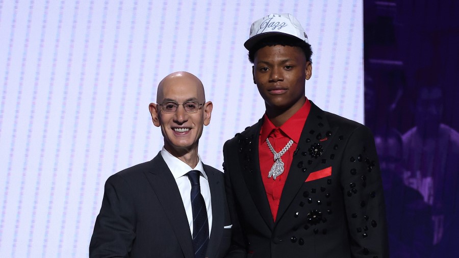Ace Bailey (R) shakes hands with NBA commissioner Adam Silver (L) after being drafted fifth overall...