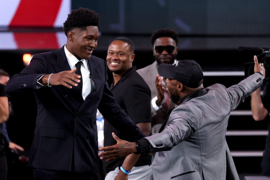 Derik Queen (L) reacts after being drafted thirteenth overall by the Atlanta Hawks during the first round of the 2025 NBA Draft at Barclays Center on June 25, 2025 in the Brooklyn borough of New York City.