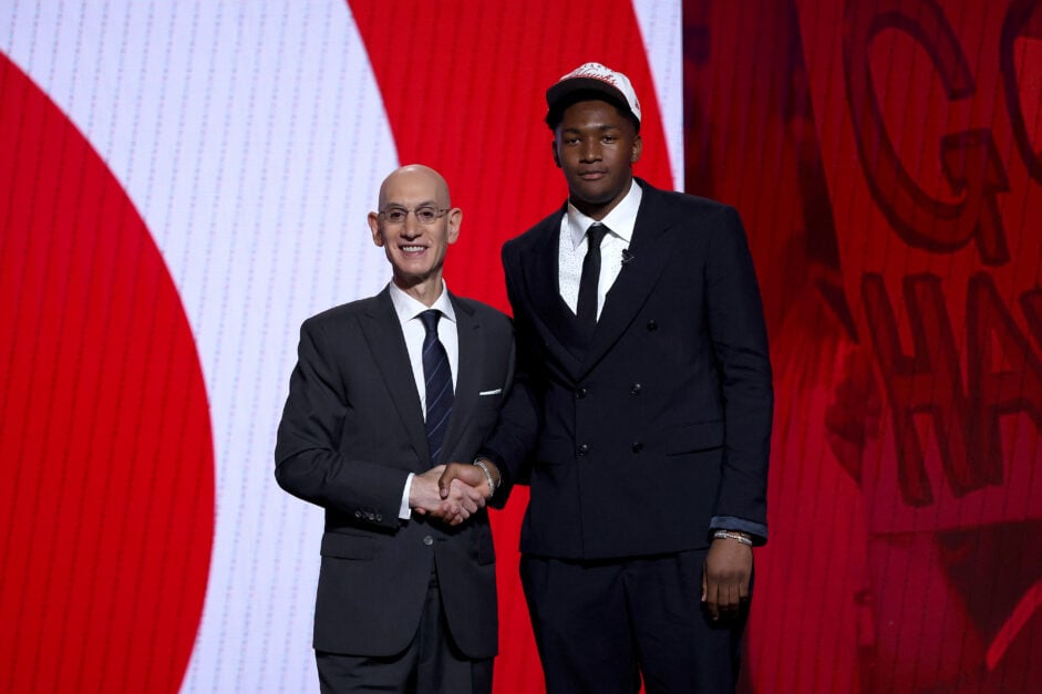 Derik Queen (R) shakes hands with NBA commissioner Adam Silver (L) after being drafted thirteenth overall by the Atlanta Hawks during the first round of the 2025 NBA Draft