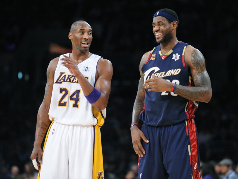 Los Angeles Lakers star Kobe Bryant argues with a referee as Cleveland Cavaliers' LeBron James laughs.