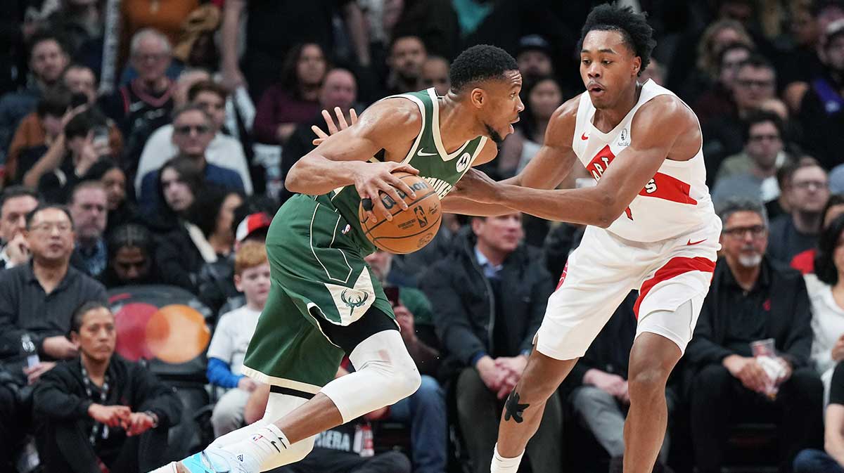 Milwaukee Bucks forward Giannis Antetokounmpo (34) controls the ball as Toronto Raptors forward Scottie Barnes (4) defends during the third quarter at Scotiabank Arena.