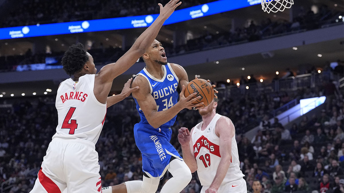 Milwaukee Bucks forward Giannis Antetokounmpo (34) drives to the basket against Toronto Raptors forward Scottie Barnes (4) in the second half at Fiserv Forum.