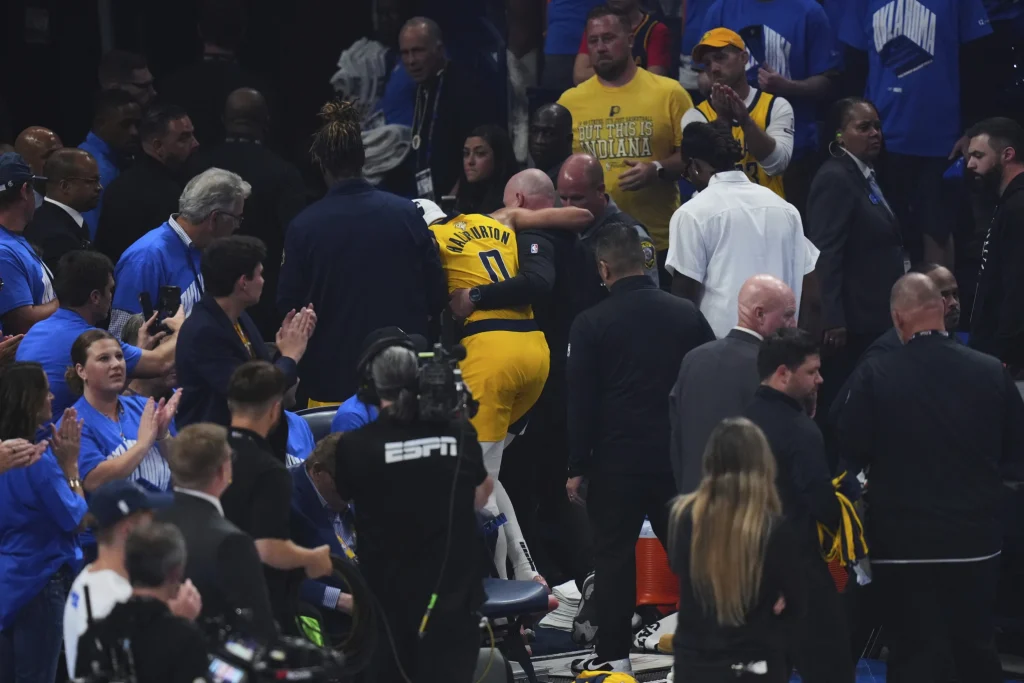 Indiana Pacers guard Tyrese Haliburton (0) leaves the court with an injury during the first half of Game 7 of the NBA Finals basketball series against the Oklahoma City Thunder Sunday, June 22, 2025, in Oklahoma City. (AP Photo/Nate Billings)