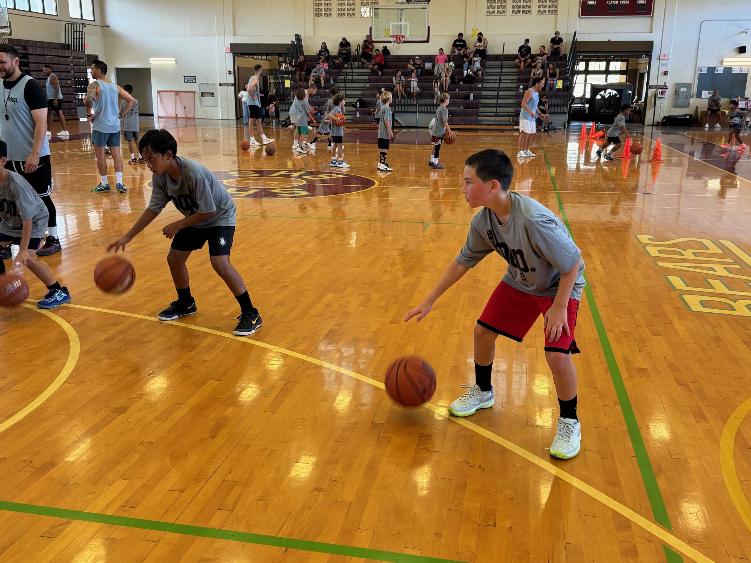 JJ Ulufale (left), an 11-year-old from Maui, and Keo Kushiyama (red shorts), a 10-year-old from University Place, Wash., became fast friends over the weekend at the Just Hoop Maui basketball camp at the Jon Garcia Gym at Baldwin High School. HUI / ROB COLLIAS photo