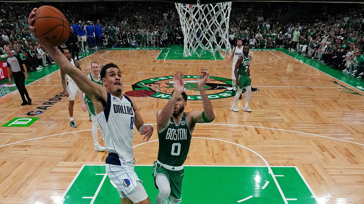 Dallas Mavericks guard Josh Green (8) shoots the ball against Boston Celtics forward Jayson Tatum (0) in game five of the 2024 NBA Finals at TD Garden.