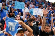 Fans raise signs after Cooper Flagg was selected with the No. 1 overall pick by the Dallas...