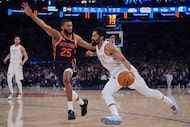 Dallas Mavericks' Spencer Dinwiddie (26) drives past New York Knicks' Mikal Bridges (25)...