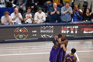 Los Angeles Lakers guard Luka Doncic (77) hugs forward LeBron James (23) after checking out...