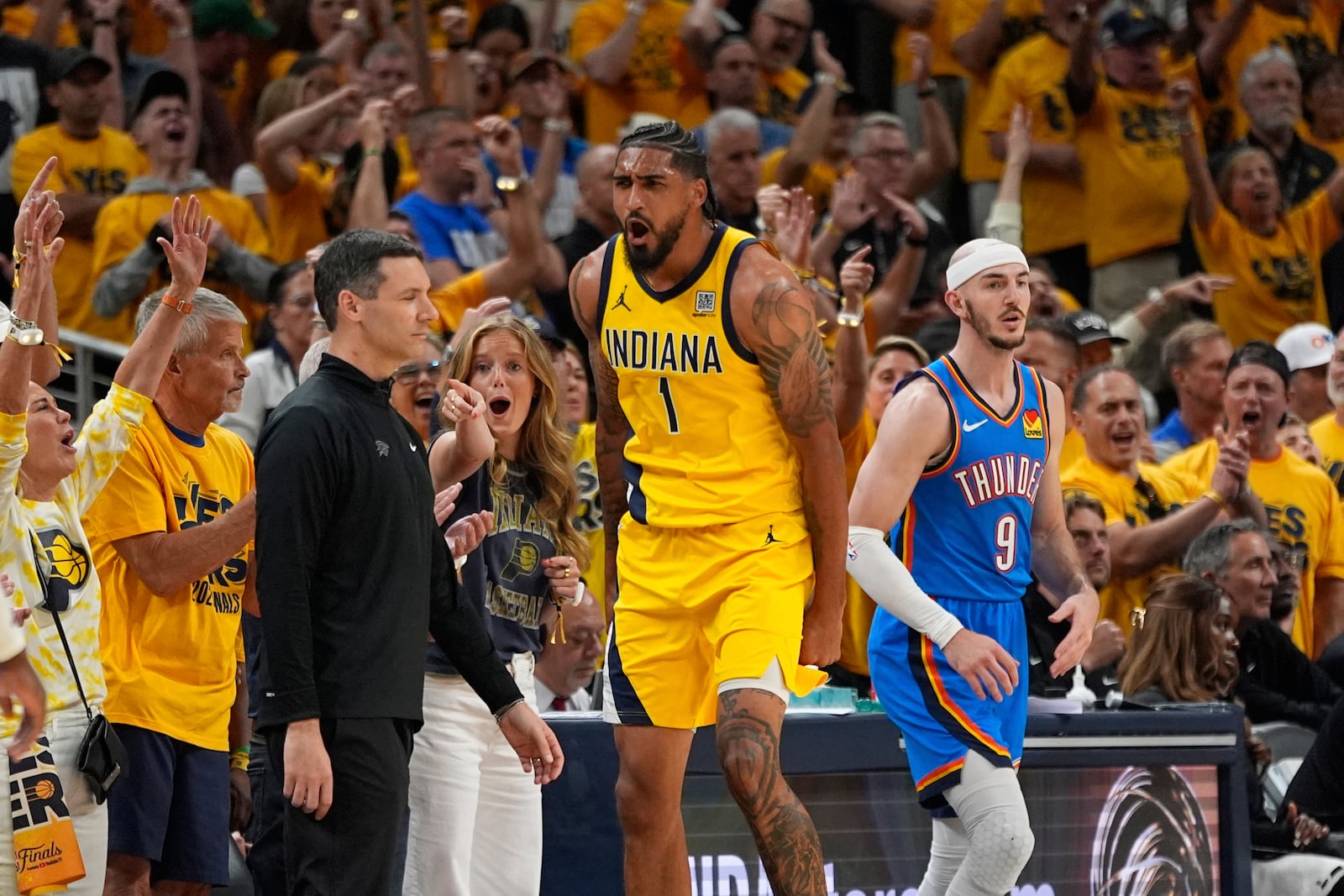 Indiana Pacers forward Obi Toppin (1) celebrates as Oklahoma City Thunder guard Alex Caruso (9) looks away during the second half of Game 6 of the NBA Finals basketball series, Thursday, June 19, 2025, in Indianapolis. (AP Photo/Abbie Parr)