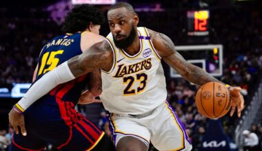 Los Angeles Lakers forward LeBron James, right, moves the ball while defended by Golden State Warriors forward Gui Santos during the first half of an NBA basketball game Saturday, Jan. 25, 2025, in San Francisco.