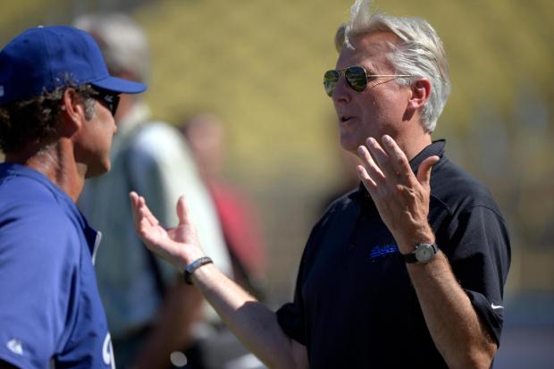 FILE - Los Angeles Dodgers co-owner Mark Walter, right, talks with manager Don Mattingly prior to their baseball game against the San Diego Padres, Sept. 3, 2012, in Los Angeles. (AP Photo/Mark J. Terrill, File)