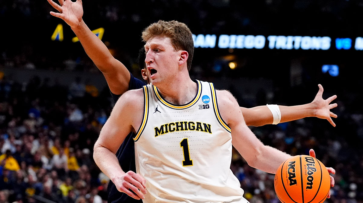 Michigan Wolverines center Danny Wolf (1) controls the ball against the UC San Diego Tritons during the first half at Ball Arena.