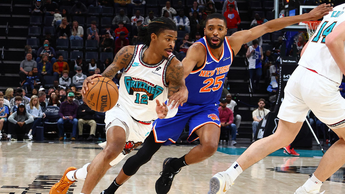 Feb 28, 2025; Memphis, Tennessee, USA; Memphis Grizzlies guard Ja Morant (12) drives to the basket as New York Knicks forward Mikal Bridges (25) defends during the third quarter at FedExForum. Mandatory Credit: Petre Thomas-Imagn Images