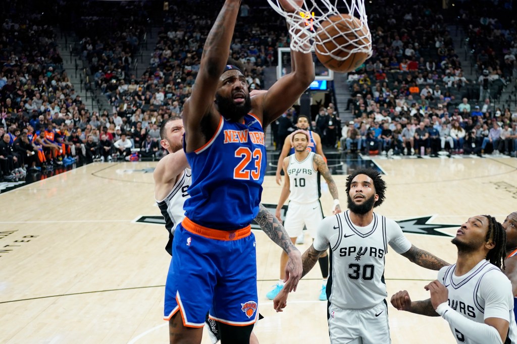 Mitchell Robinson, who scored 13 points and grabbed 11 rebounds, slams home a dunk during the Knicks' 120-105 loss to the Spurs on March 19, 2025.