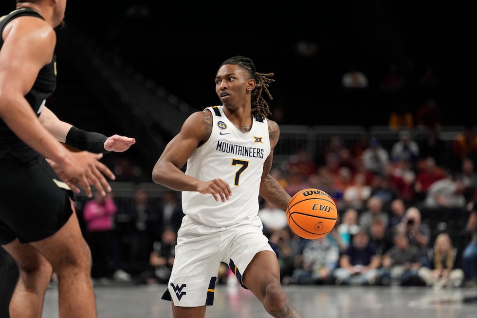 West Virginia's Javon Small dribbles during the second half of an NCAA college basketball game...
