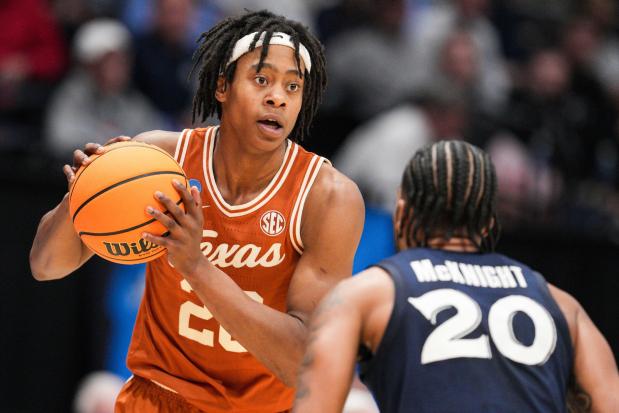 Texas' Tre Johnson controls the ball against Xavier's Dayvion McKnight during a First Four game on March 19, 2025, in Dayton, Ohio. (AP Photo/Jeff Dean)