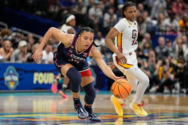UConn guard Azzi Fudd (35) brings the ball up court during the first half of the national championship game at the Final Four of the women's NCAA college basketball tournament, Sunday, April 6, 2025, in Tampa, Fla. (AP Photo/Chris O'Meara)
