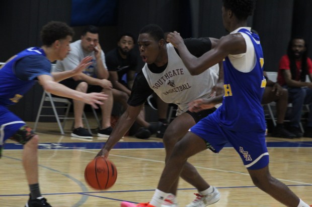 The Southgate Anderson boys' basketball team, white jerseys, battled Dearborn...