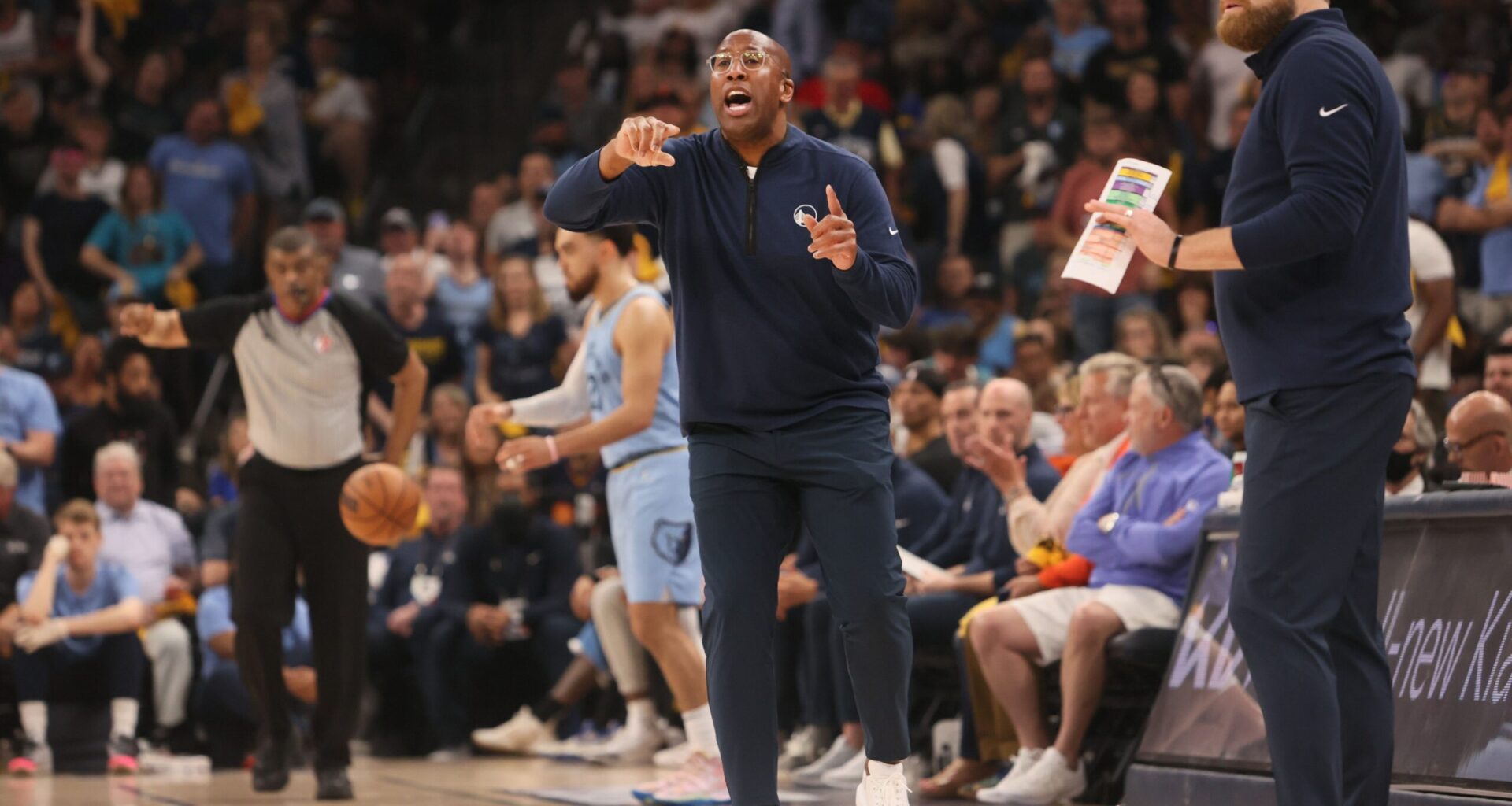 Memphis Grizzlies Head Coach Taylor Jenkins (right) and Interim Golden State Warriors Head Coach Mike Brown (left) lead their teams from the sidelines during game five of the second round for the 2022 NBA playoffs at FedExForum.