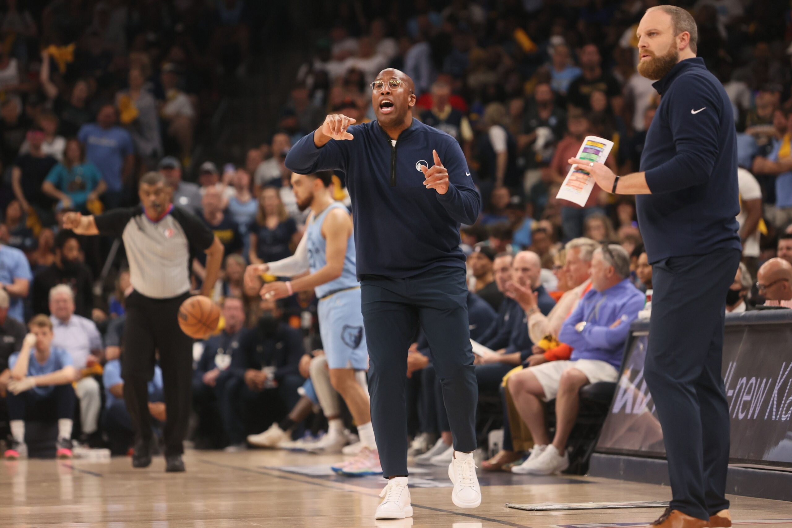 Memphis Grizzlies Head Coach Taylor Jenkins (right) and Interim Golden State Warriors Head Coach Mike Brown (left) lead their teams from the sidelines during game five of the second round for the 2022 NBA playoffs at FedExForum.