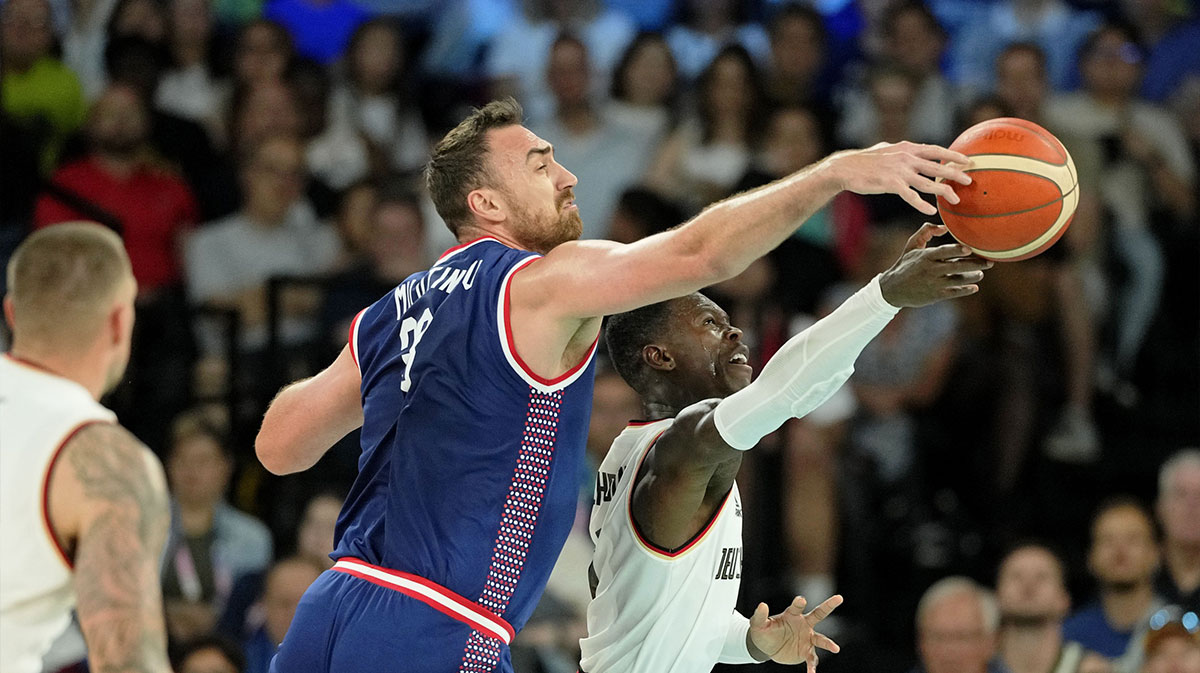 Germany point guard Dennis Schroder (17) reaches for the ball against Serbia centre Nikola Milutinov (33) in the men's basketball bronze medal game during the Paris 2024 Olympic Summer Games at Accor Arena.