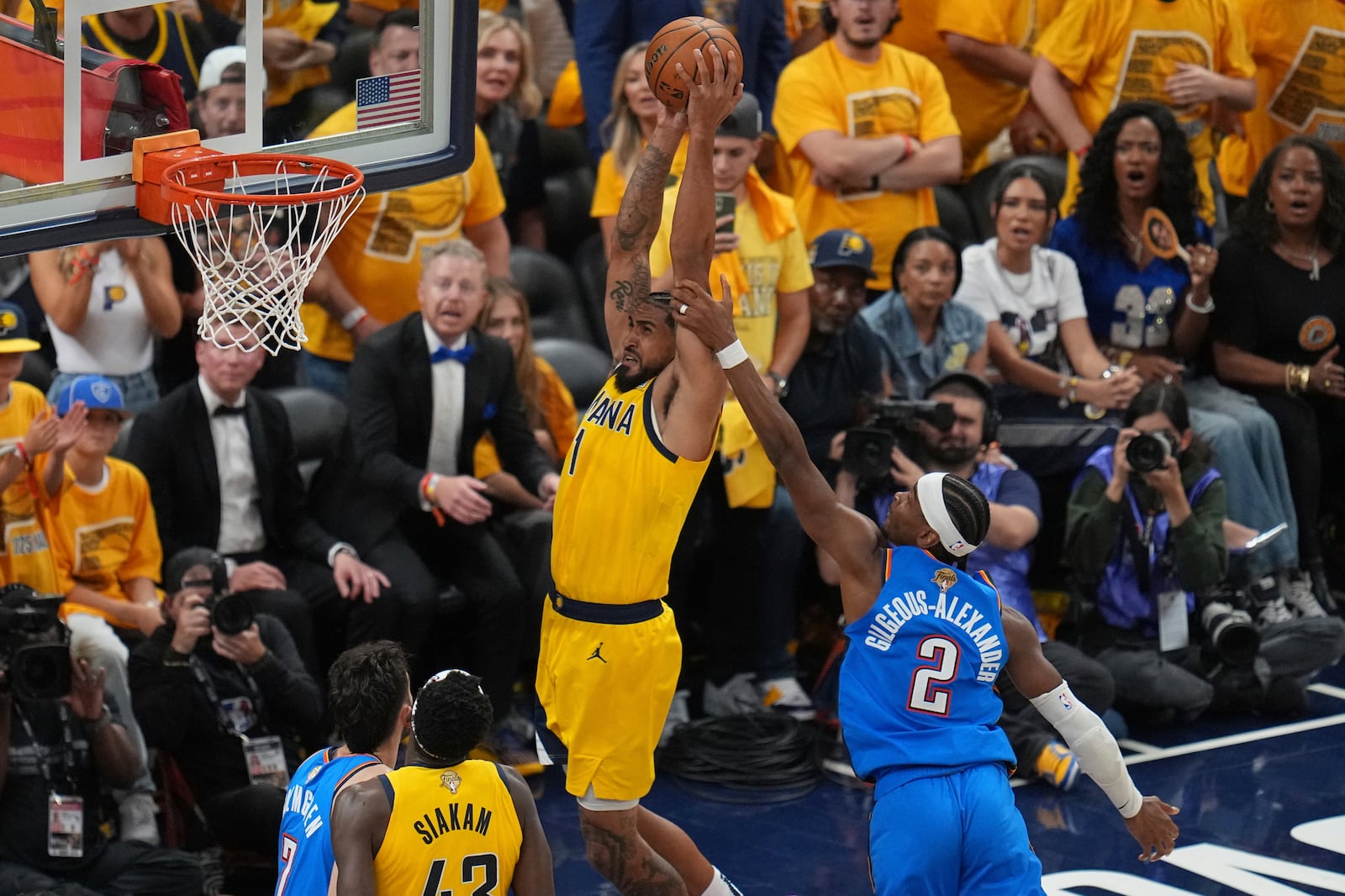 Indiana Pacers forward Obi Toppin (1) dunks as Oklahoma City Thunder guard Shai Gilgeous-Alexander (2) defends during the second half of Game 4 of the NBA Finals basketball series, Friday, June 13, 2025, in Indianapolis. (AP Photo/Michael Conroy)