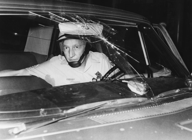Chicago police Sgt. James Delaney sits in patrol car after...