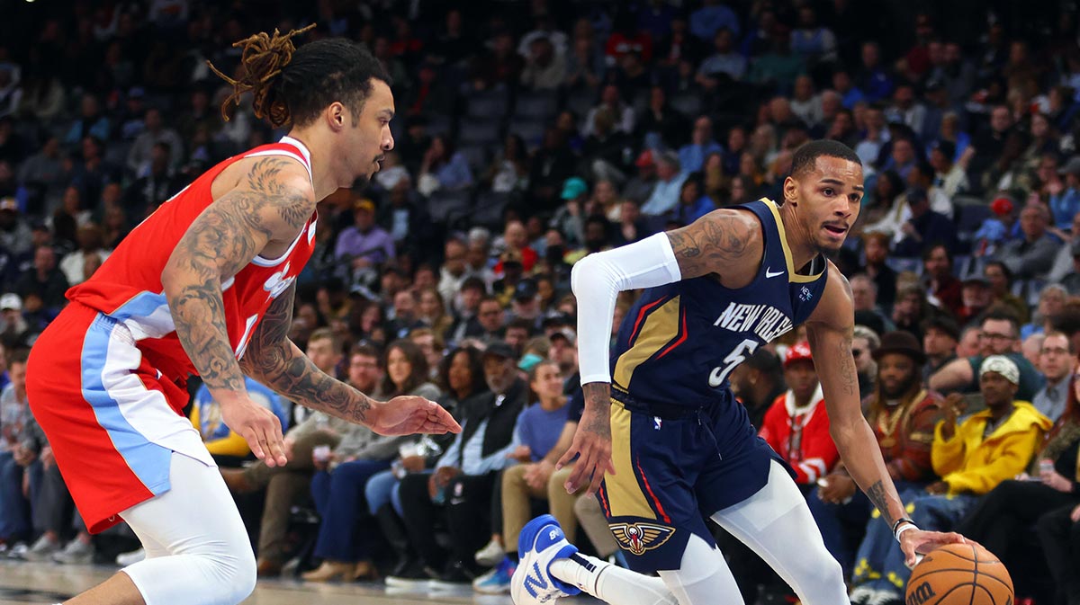 Pelicans guard Dejounte Murray (5) drives to the basket as Memphis Grizzlies forward Brandon Clarke (15) defends during the third quarter at FedExForum