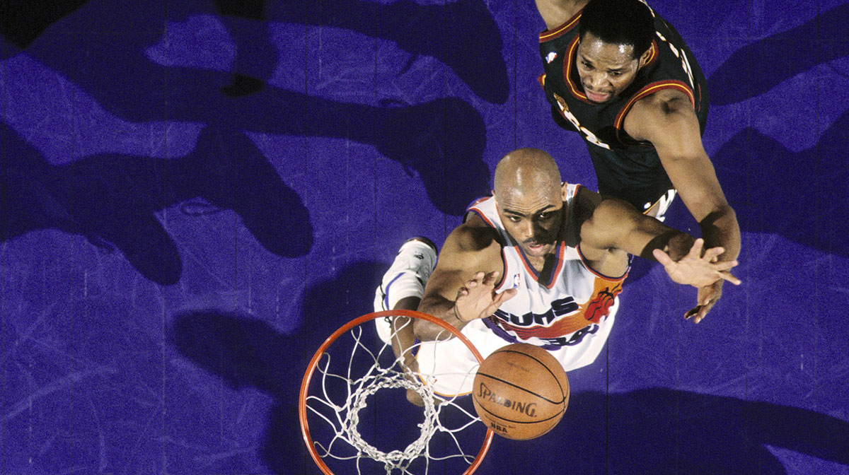 Phoenix Suns forward Charles Barkley (34) is defended by Seattle Supersonics center Sam Perkins (right) at America West Arena.