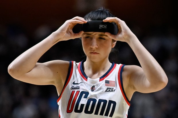 UConn guard Caroline Ducharme adjusts a protective headband as she returned to action for UConn women's basketball in 2025. (AP Photo/Jessica Hill)