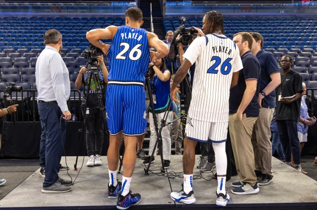 Orlando Magic players Tristan da Silva, left and Kentavious Caldwell-Pope...