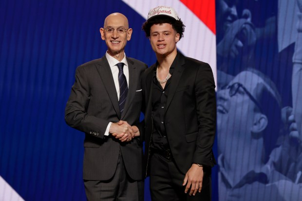 Walter Clayton Jr. poses for a photo with NBA commissioner Adam Silver after being selected 18th by the Washington Wizards in the first round of the NBA basketball draft, Wednesday, June 25, 2025, in New York. (AP Photo/Adam Hunger)