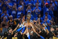 Oklahoma City Thunder players hold up the Larry O'Brien Championship Trophy after they won...