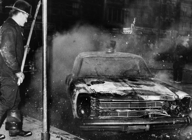 One of the three squad cars burned June 12, 1966,...