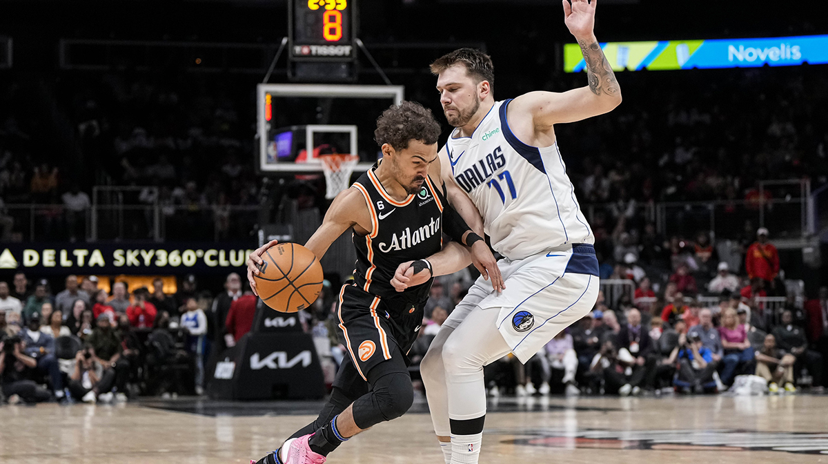 Atlanta Hawks guard Trae Young (11) dribbles against Dallas Mavericks guard Luka Doncic (77) during overtime at State Farm Arena.