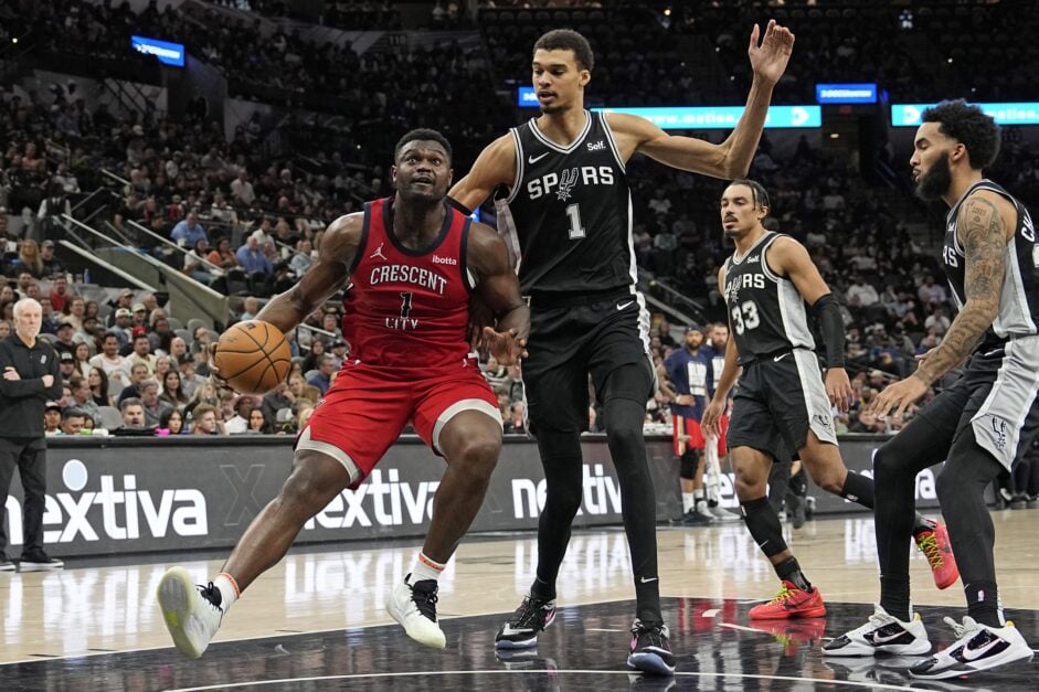 New Orleans Pelicans forward Zion Williamson handles the ball against San Antonio Spurs center Victor Wembanyama