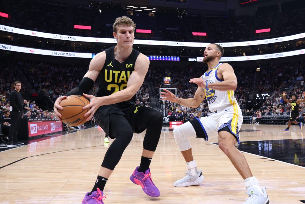 Oct 25, 2024; Salt Lake City, Utah, USA; Utah Jazz forward Lauri Markkanen (23) and Golden State Warriors guard Stephen Curry (30) go for a loose ball during the third quarter at Delta Center. Mandatory Credit: Rob Gray-Imagn Images