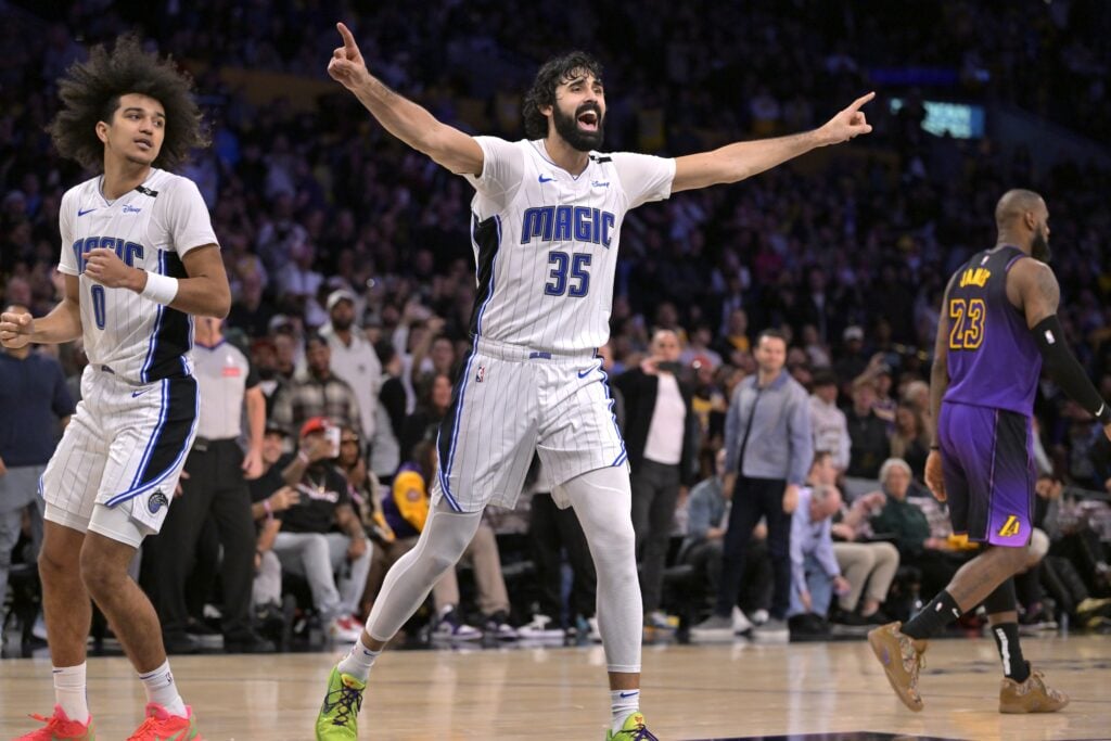 Nov 21, 2024; Los Angeles, California, USA; Los Angeles Lakers forward LeBron James (23) walks off the court as Orlando Magic center Goga Bitadze (35) celebrates after a 119-118 win at Crypto.com Arena. Mandatory Credit: Jayne Kamin-Oncea-Imagn Images