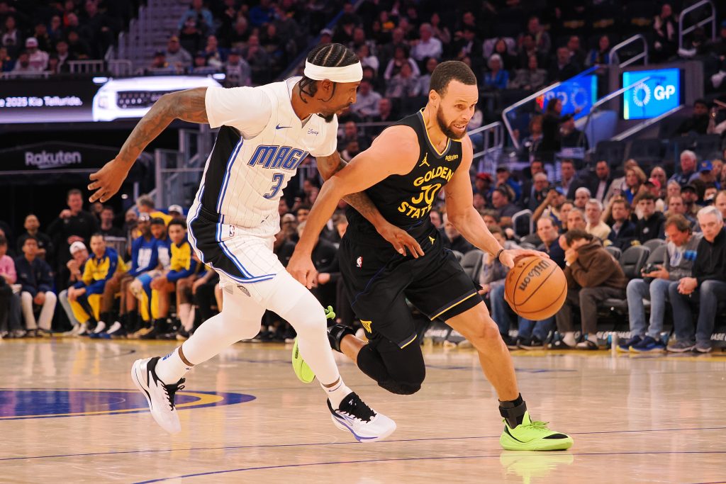 Golden State Warriors guard Stephen Curry (30) drives in against Orlando Magic guard Kentavious Caldwell-Pope (3) during the third quarter Monday at Chase Center. [Kelley L Cox-Imagn Images]