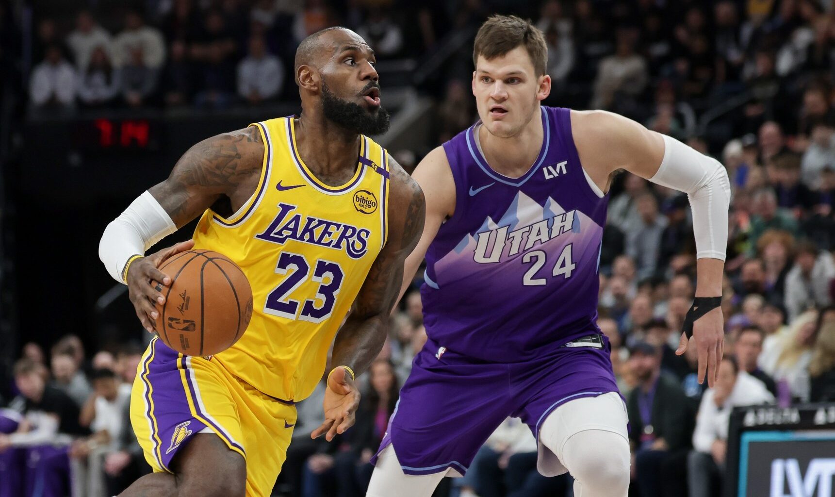 Feb 12, 2025; Salt Lake City, Utah, USA; Los Angeles Lakers forward LeBron James (23) dribbles past Utah Jazz center Walker Kessler (24) during the first quarter at Delta Center. Mandatory Credit: Chris Nicoll-Imagn Images