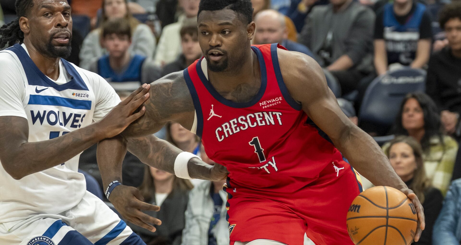 New Orleans Pelicans forward Zion Williamson (1) drives to the basket past Minnesota Timberwolves center Naz Reid (11) in the second half at Target Center.