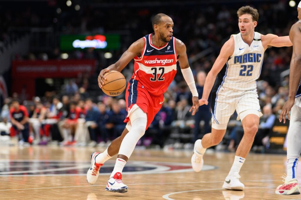 Mar 21, 2025; Washington, District of Columbia, USA; Washington Wizards forward Khris Middleton (32) handles the ball against Orlando Magic forward Franz Wagner (22) during the third quarter at Capital One Arena. Mandatory Credit: Reggie Hildred-Imagn Images