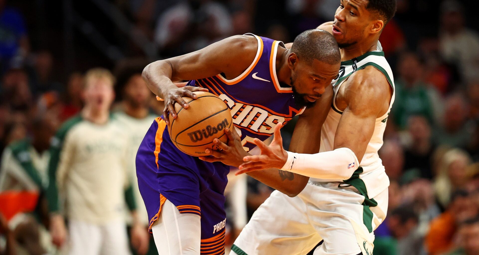 Phoenix Suns forward Kevin Durant (35) handles the ball against Milwaukee Bucks forward Giannis Antetokounmpo (34) during the fourth quarter at Footprint Center.